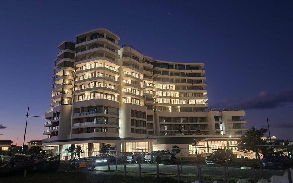 Completed mixed-use building at dusk