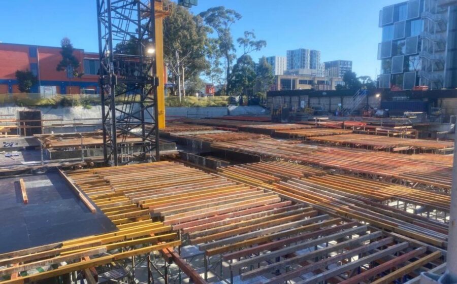 Apex podium deck formwork with joists and bearers under a tower crane